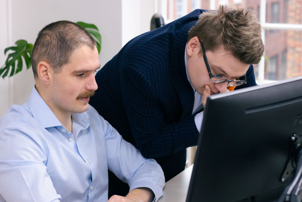 Two creative business people looking at a computer